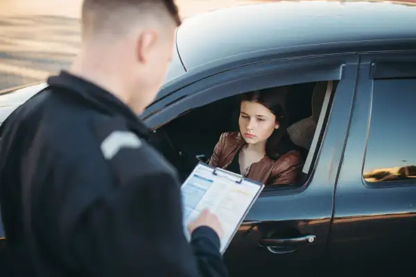 Teen driver getting a ticket from a police officer